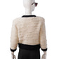 Cream-colored cardigan with black details