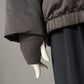 Schwarzbraune Daunenjacke mit Kapuze